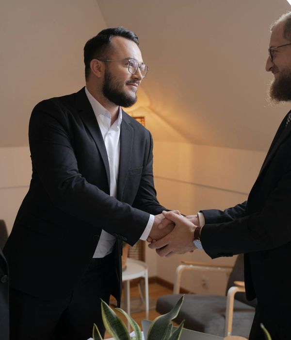 Business handshake between international trade partners in modern office