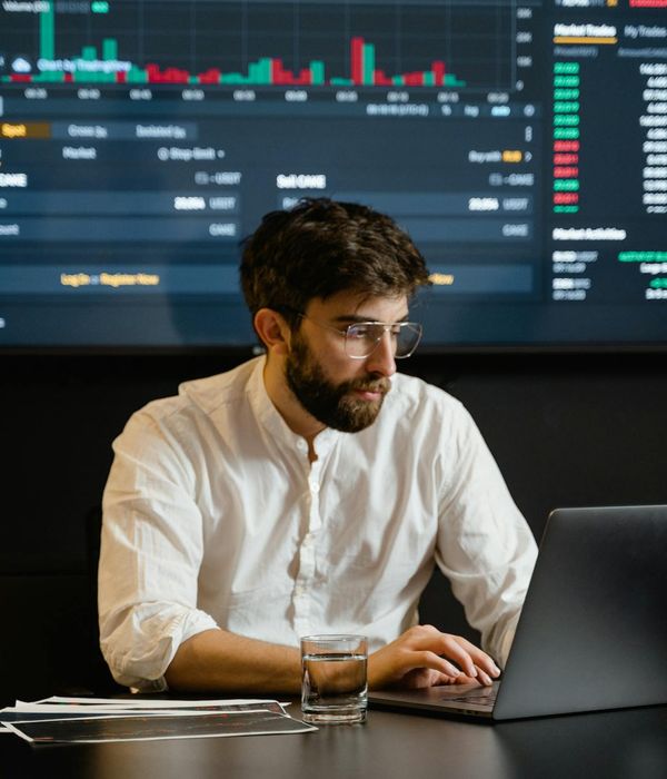 Male business analyst reviewing data on computer